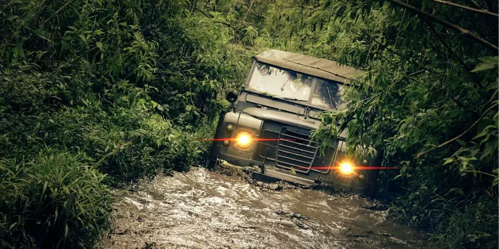 a jeep driving through mud